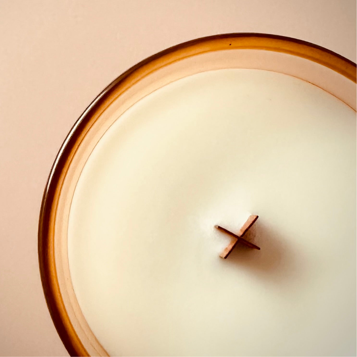 An overhead photo of our 8oz Floating By Candle highlighting the ‘X’ shaped wooden wick.