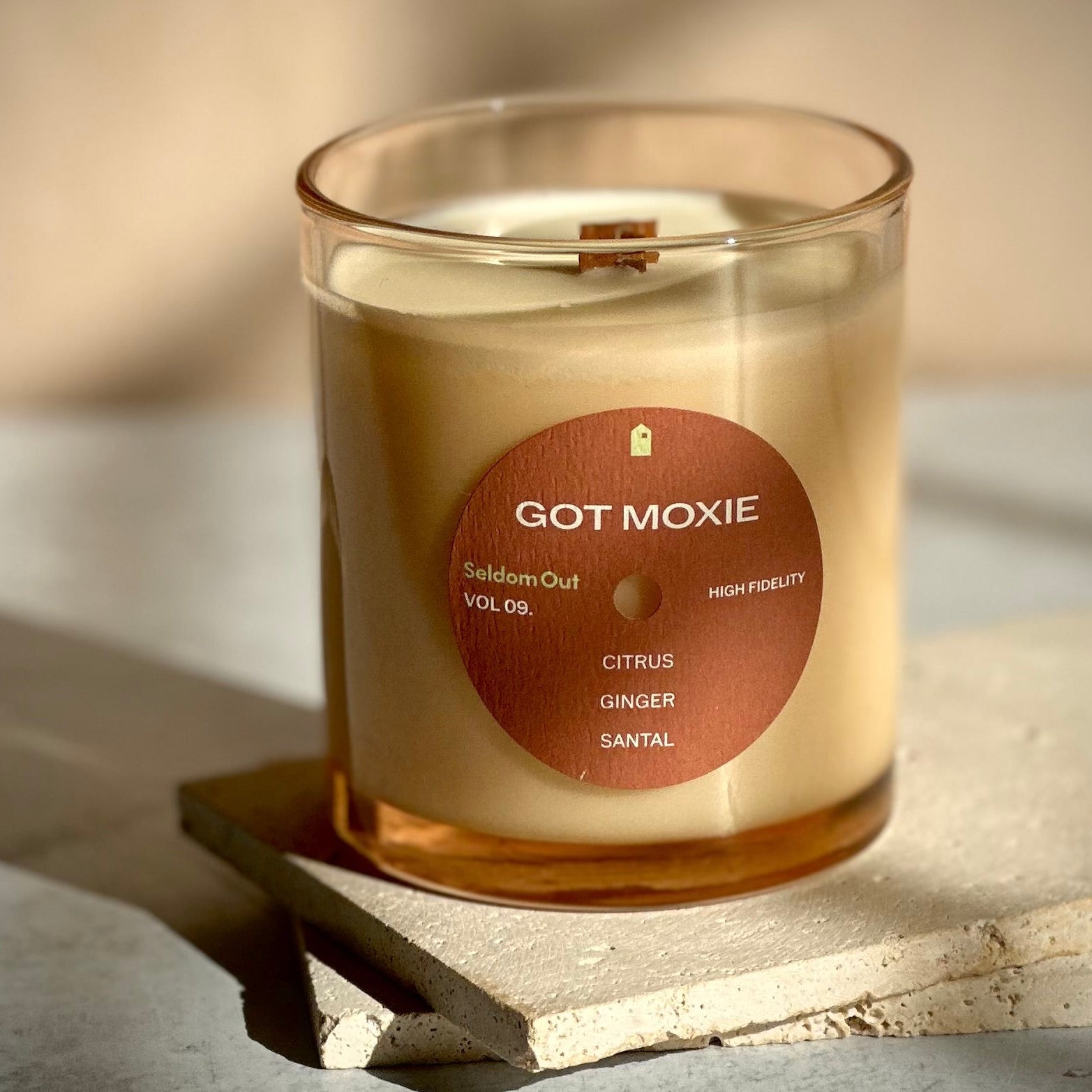 Candle with a label on a stone surface