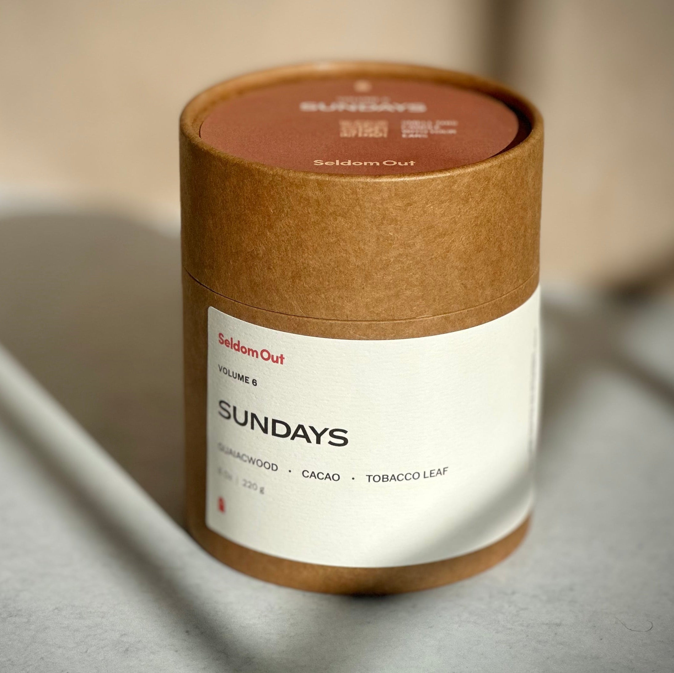 Cylindrical product packaging with 'Sundays' branding on a neutral background