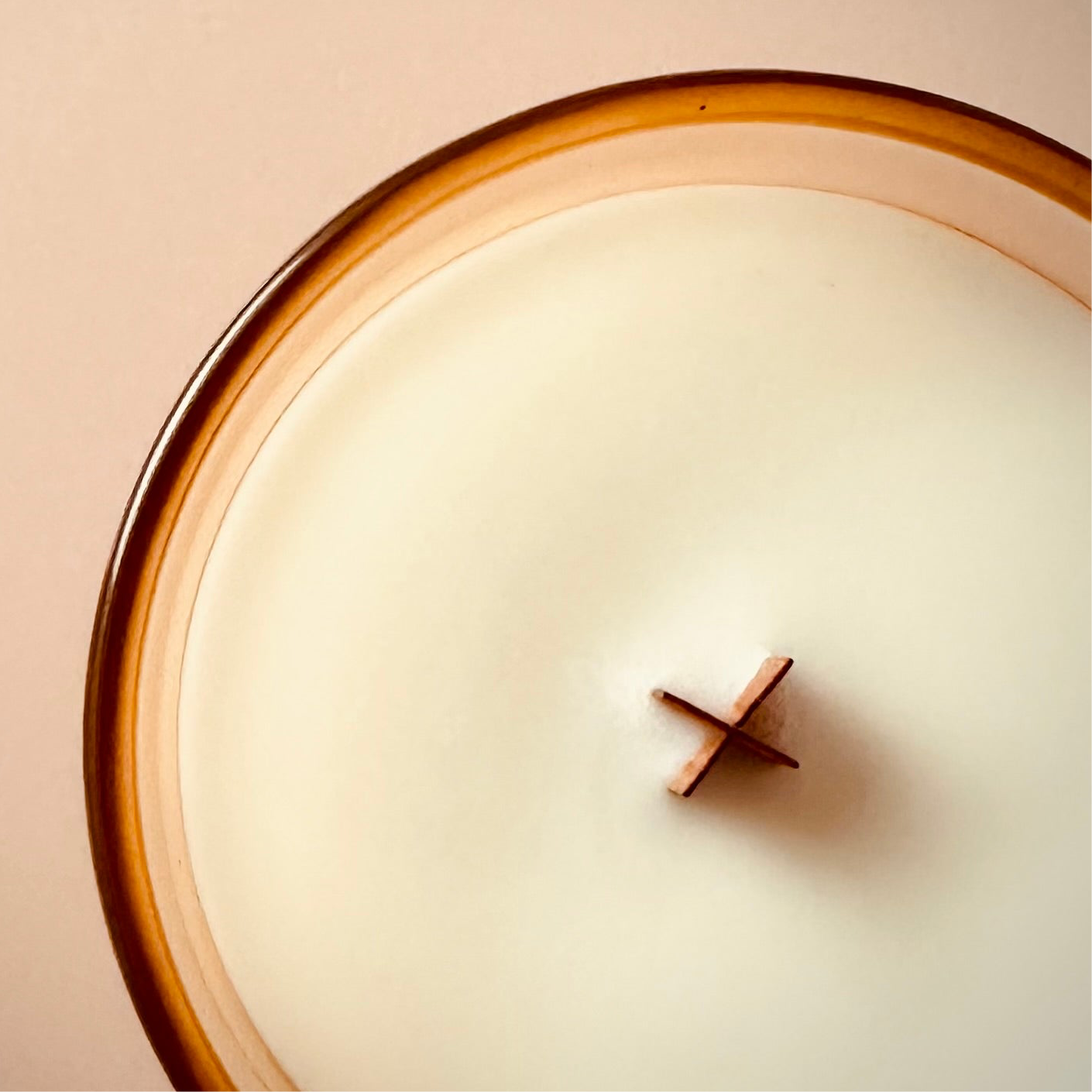 An overhead shot of our 8oz Jam Hot Scented Candle, that highlights the X shaped wood wick.