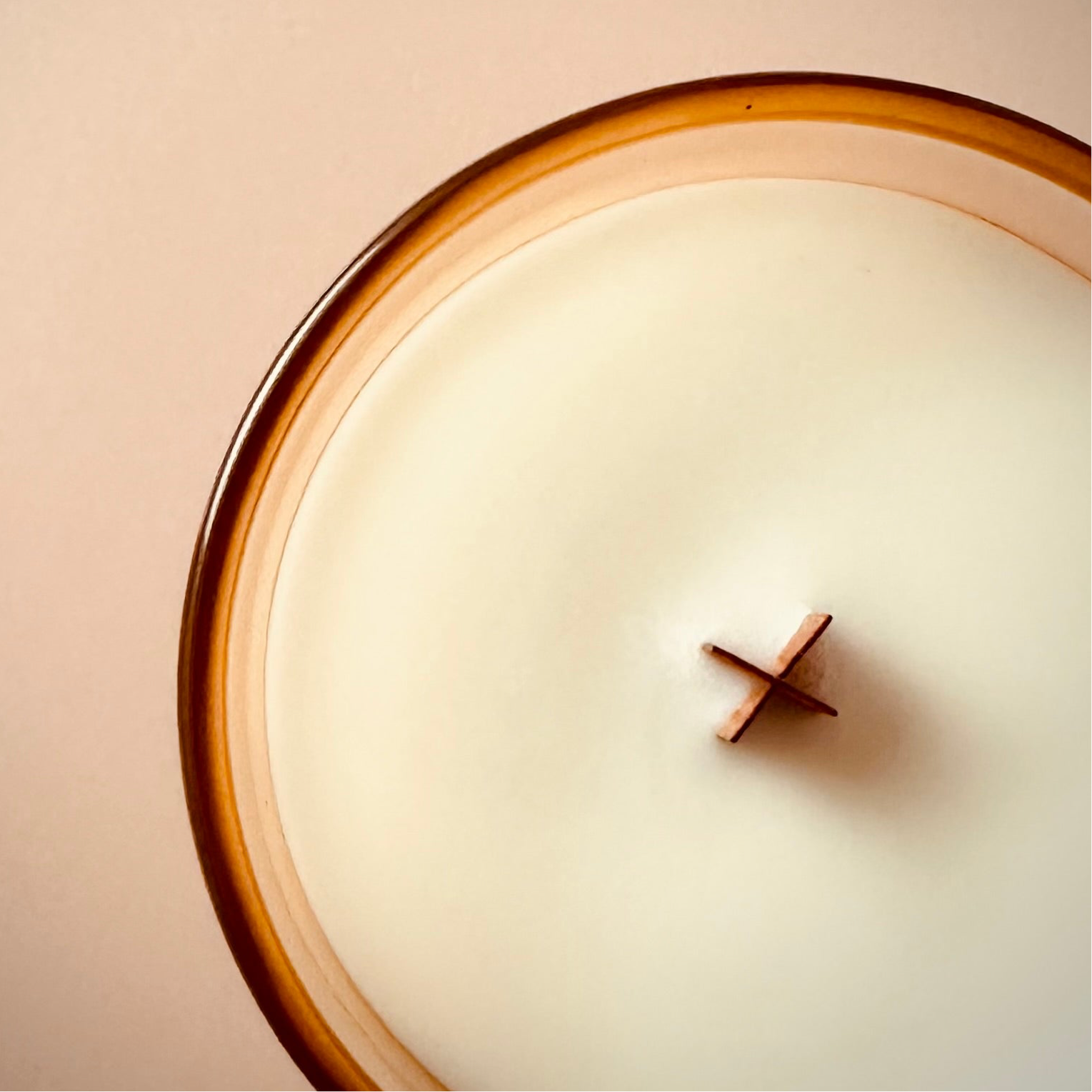 A photo taken looking down at the top of our 8oz Paris for a Day scented candle, to highlight the X shaped wood wick.