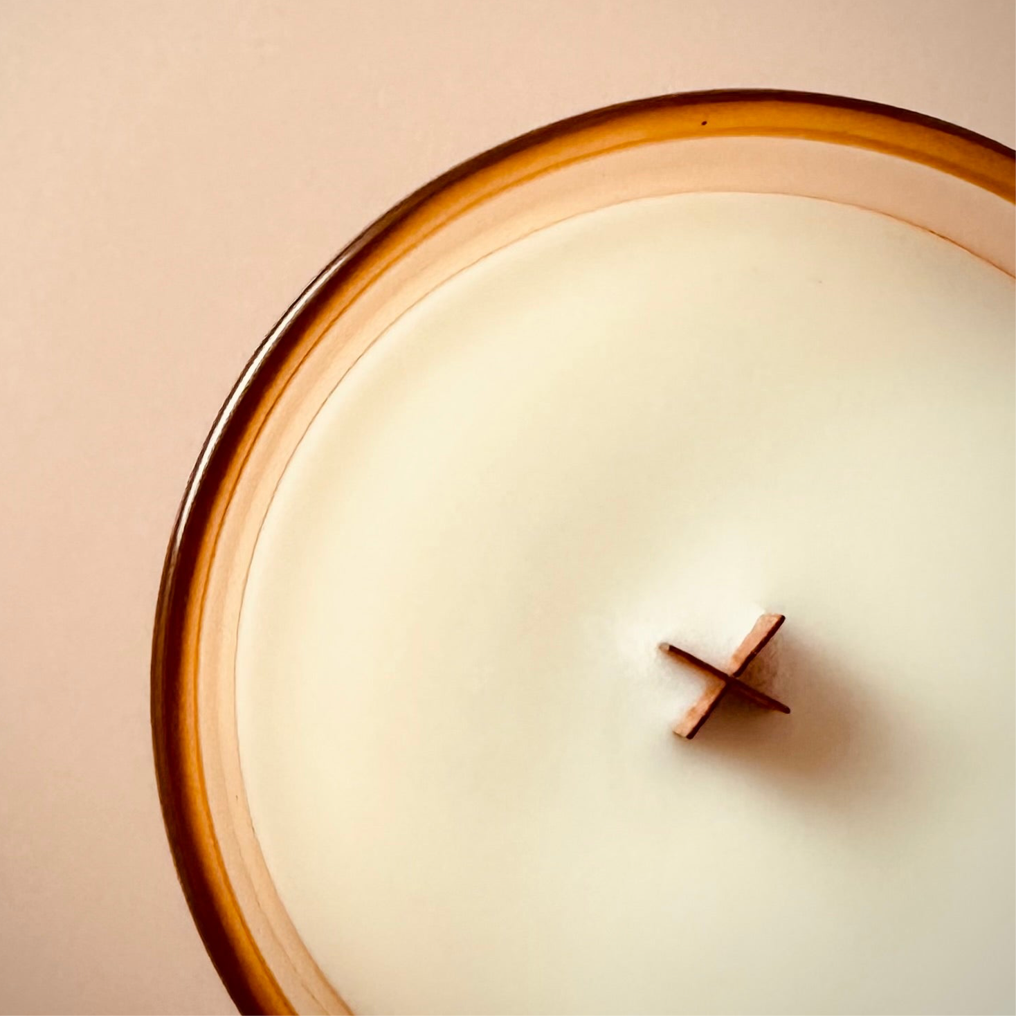 An overhead image of our 8oz True Romance Scented Candle, highlighting the wooden X shaped wick.