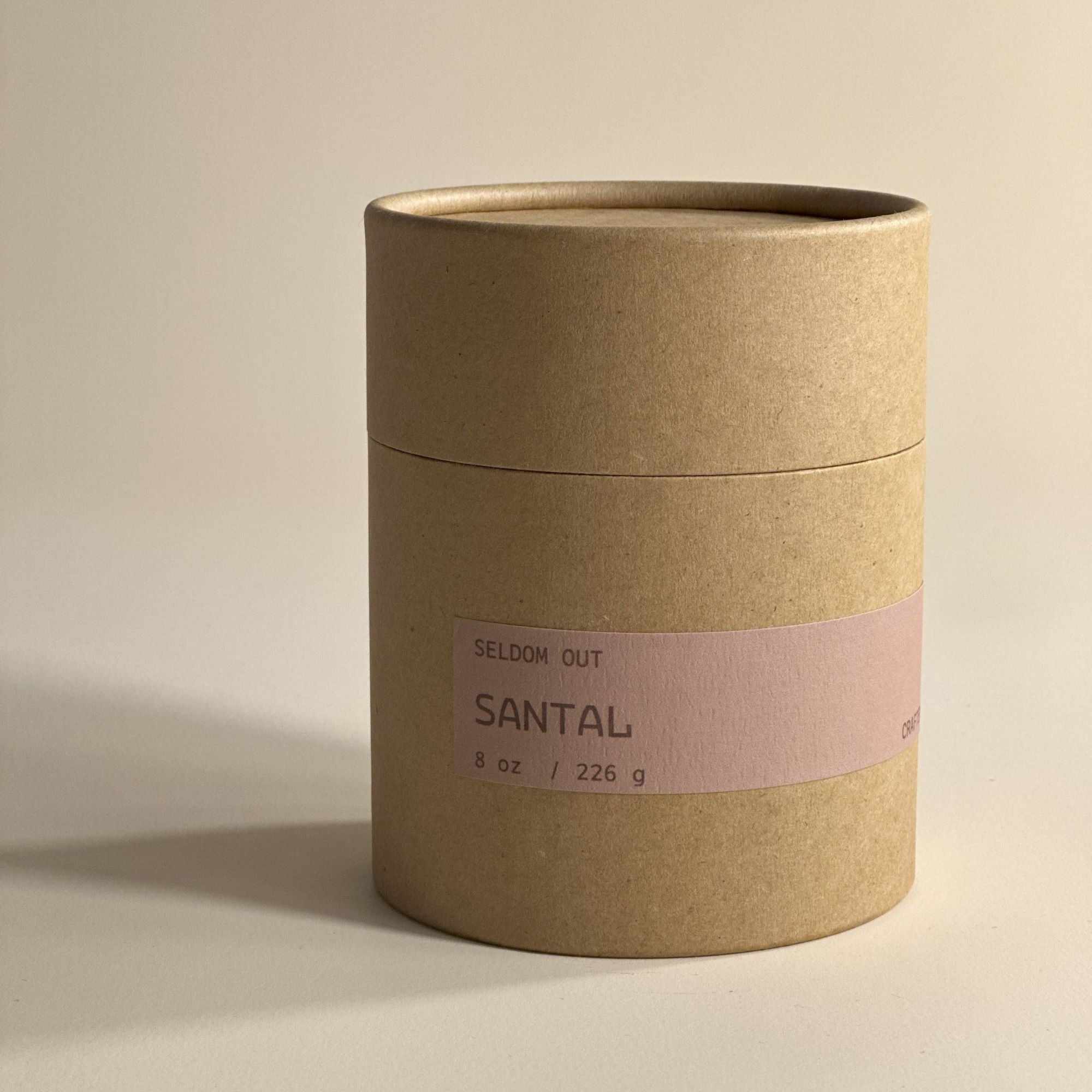 A portrait image of the box for our 8oz Santal scented candle made in a clear glass jar. Made with sturdy Kraft paperboard it features a long thin label.